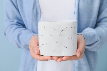 Woman holding toilet paper with nails, closeup. Hemorrhoids concept