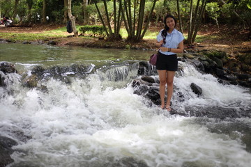 Woman and Nam Tum waterfall in Chanthaburi at thailand	
