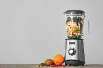 Modern blender and products on table