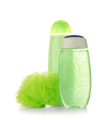 Shower gels and loofah on white background