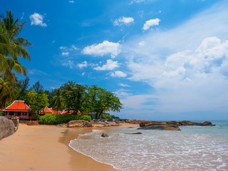 Uninhabited tropical beach with blue sky