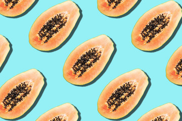 Seamless pattern with papaya. Tropical abstract background. Top view. Creative design, minimal flat lay concept. Summer time. Tropical travel, exotic papaya fruit. Vegan and vegetarian food