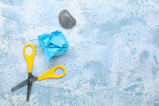 Scissors, rock and paper on color background
