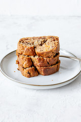 Fresh banana bread on a white background, vertical 