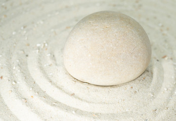 Fototapeta na wymiar White stone in white sand, passing through the circles, copy space