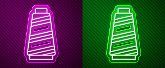Glowing neon line Sewing thread on spool icon isolated on purple and green background. Yarn spool. Thread bobbin. Vector Illustration
