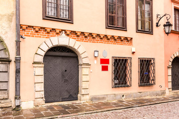 Fototapeta na wymiar Entrance to the medieval house in the Old Town. Winter season in Warsaw, Poland.