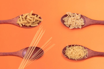 Pasta on a wooden spoon. Different types of pasta