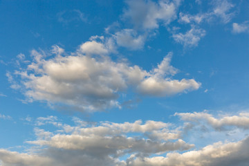 Cloudscape with white clouds at sunny day