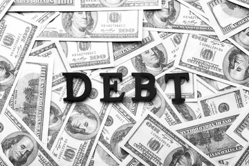 Word DEBT on dollar banknotes