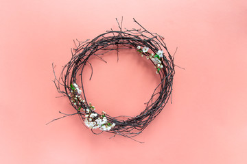 Fototapeta premium on a pink background, spring decorative wreath of branches of flowering cherry trees. room design