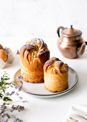 Homemade kraffins on a white background with a teapot and flowers
