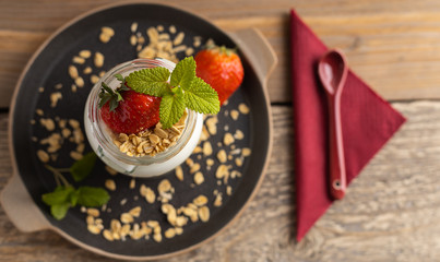 Vegetarian breakfast of yogurt with strawberry and muesli. Top view.