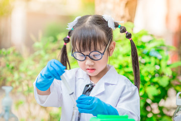 Close-up background view of a cute girl Who are learning science, business concepts, experimenting with chemical coloring or marketing planning