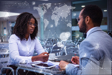 Serious business colleagues discussing ongoing project over cup of coffee. Business man and woman...