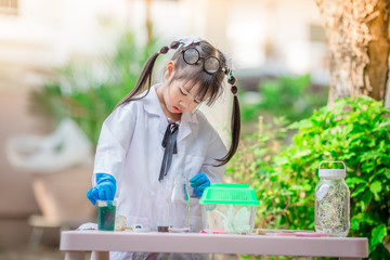 Close-up background view of a cute girl Who are learning science, business concepts, experimenting with chemical coloring or marketing planning