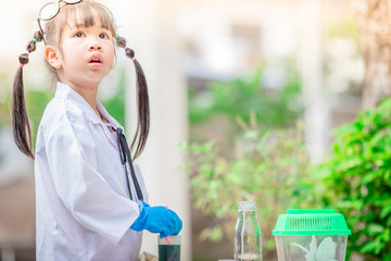 Close-up background view of a cute girl Who are learning science, business concepts, experimenting with chemical coloring or marketing planning