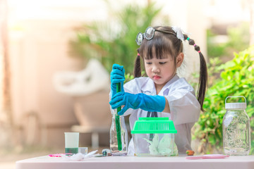 Close-up background view of a cute girl Who are learning science, business concepts, experimenting with chemical coloring or marketing planning