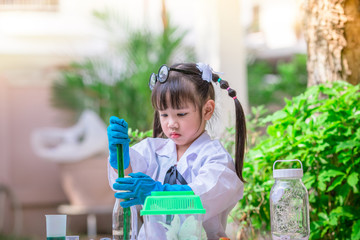 Close-up background view of a cute girl Who are learning science, business concepts, experimenting with chemical coloring or marketing planning