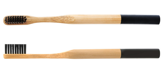 Bamboo toothbrushes with charcoal bristles on white background