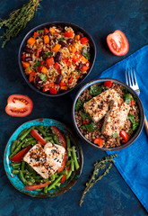 three vegan dishes on a dark blue background, top view