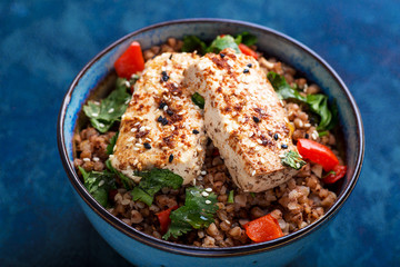 buckweat with tofu and pepper on a blue background