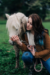 Girl interacting with her Shetland Pony.
