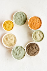 cosmetic clay - Yellow, red, white, blue and black dry powder - top-down flat lay