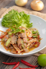 Spicy Sliced Beef Salad, Thai style - wooden background with copy space