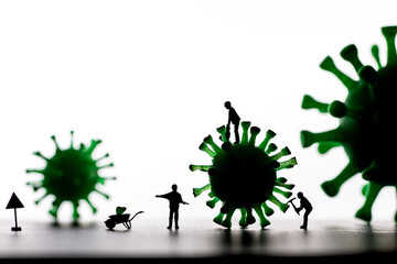 Silhouettes of Miniature workers take a sample from a viral model, on a white background close-up....