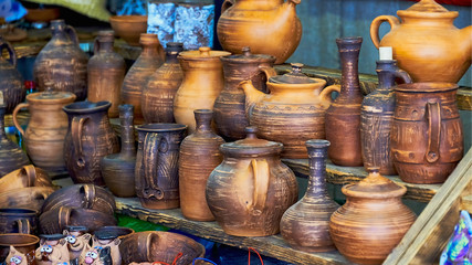 Fototapeta na wymiar Belarus, Minsk, August 2019. A small street shop selling Souvenirs. A large assortment of handmade pottery.