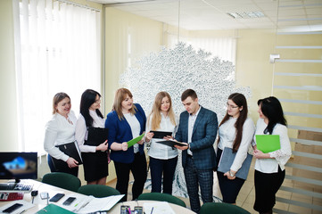 Young business people group of bank workers with clipboards have meeting and working in modern...