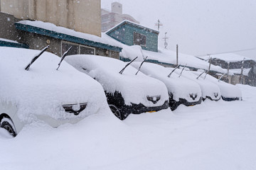 The car is parked in the snow in Japan.