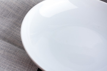 Empty plate with grey napkin.