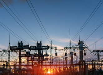 High-voltage power lines at sunset or sunrise. High voltage electric transmission tower