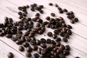 Coffee beans are scattered on the wooden table