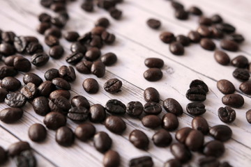 Coffee beans are scattered on the wooden table