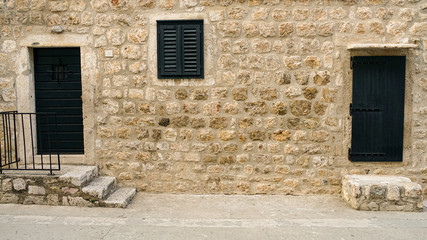 Fototapeta na wymiar Windows and doors in old stone houses of the Dubrovnik fortress