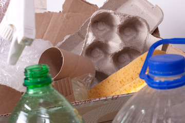 Household garbage with plastic bottles, cellophane bags, paper waste and air-bubble wrap. The concept of separate disposal, environmental pollution. Processing of wastes.