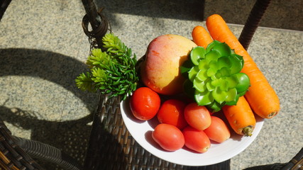Tomatoes, carrots on the table glass
