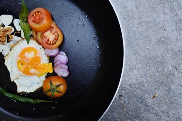omelet with seasonings and vegetables on a pan