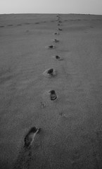 footprints on the beach empty no one distance