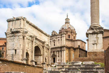 Fototapeta na wymiar The Arch of Septimius Severus (in italian Arco di Settimo Severo) and Santi Luca e Martina Roma