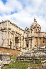 Fototapeta na wymiar The Arch of Septimius Severus (in italian Arco di Settimo Severo) and Santi Luca e Martina Roma