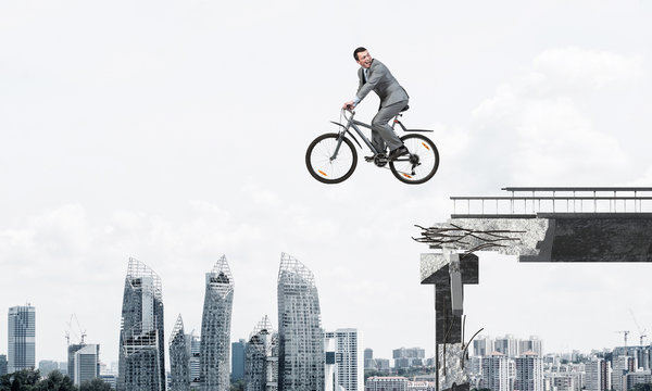 Businessman Commuting To Work By Bike