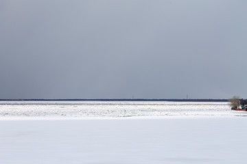 white snow and gray sky merge on the horizon