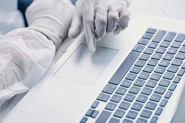 Bio hazard man with laptop. Business man working on laptop computer in quarantine.