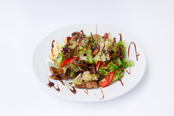 Fresh mushroom iceberg salad with eggs, tomatoes and sauce. Restaurant dish on white plate  on white background.