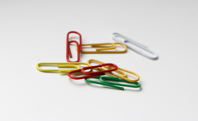 colorful paper clips on white background