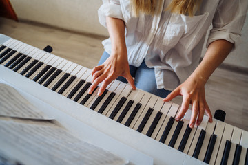 Woman is quarantined at home coronavirus. Attractive girl in a white shirt and jeans staying at...